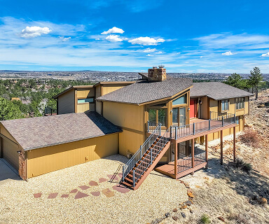 Single-story ranch home with xeriscape rock front yard and attached two-car garage in Colorado Springs | Logo Inc Real Estate